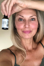 Beautiful Woman holding Purely Radiant Face Oil by ZEN